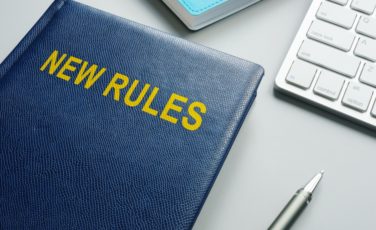 book with title new rules and regulations in an office