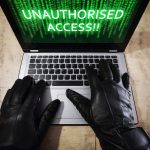 Hacker stealing data from a laptop